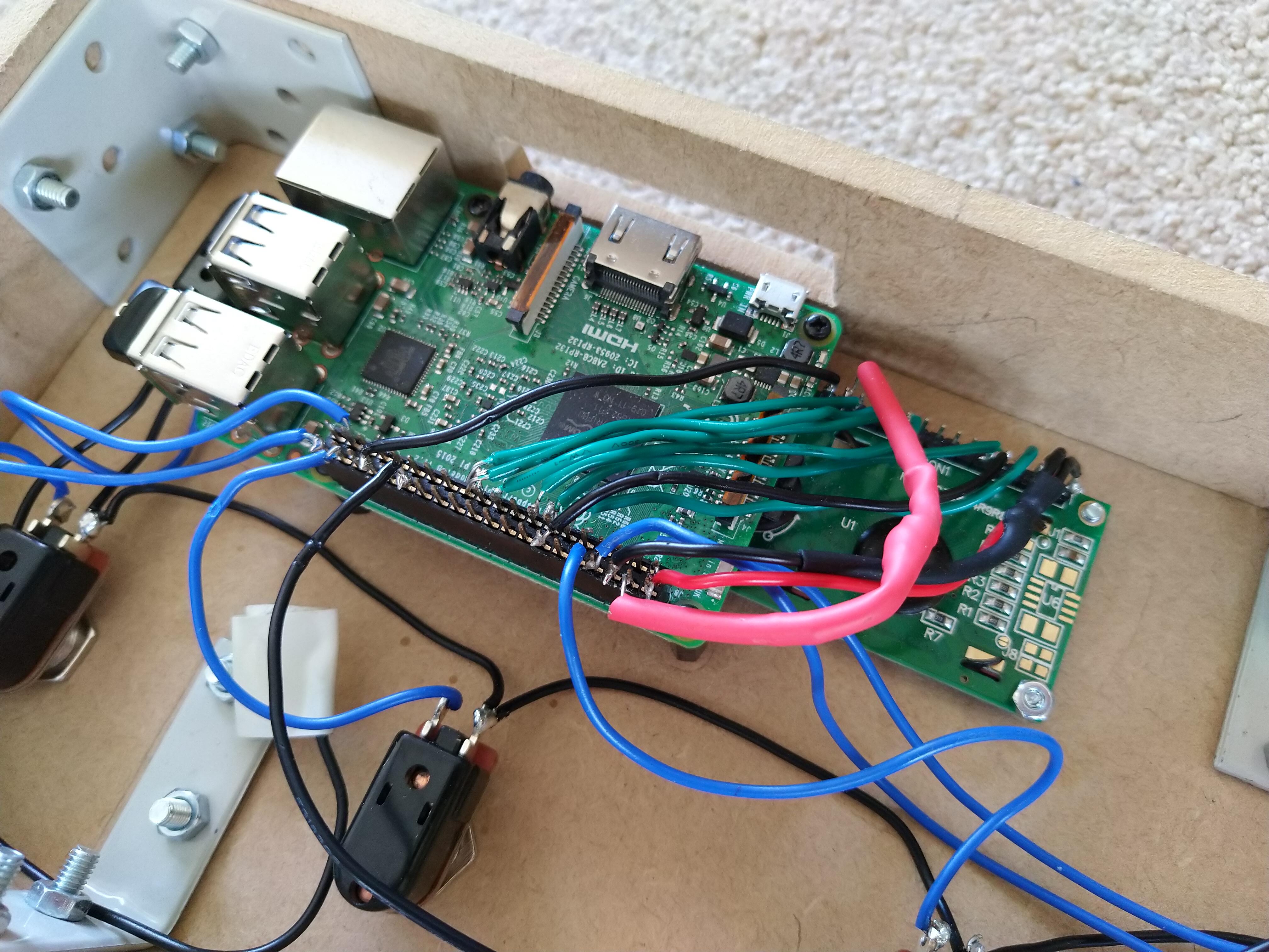 A Raspberry Pi connected by various soldered wires to an LCD screen. Both components are installed into the lid of the SoundFloored pedal
